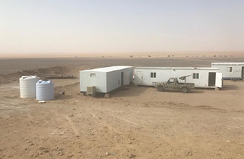 Container and vehicle in the desert (photo)
